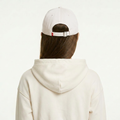 A female model wearing the Smith's 1906 UCP02 White Cap is showing the back.