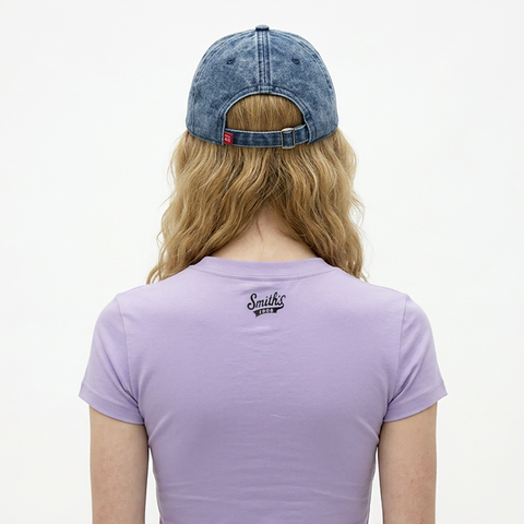 A female model wearing the Smith's 1906 UCP04 Blue Cap is showing the back.