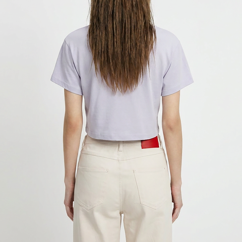 A female model wearing the Smith's 1906 WTE01 Lilac T-shirt is showing the back.