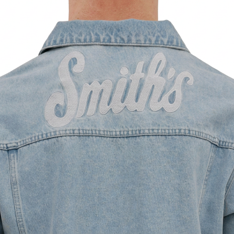 A close-up back view of a male model wearing the Smith's 1906 MJK01 Light Blue Denim Jacket.