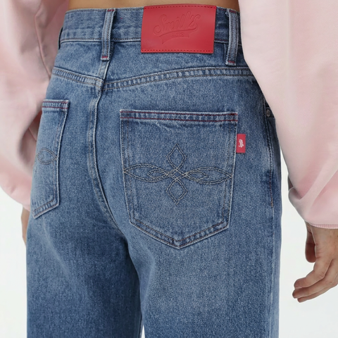 A close-up back view of a female model wearing the Smith's 1906 WJN01 Light Blue Jeans.