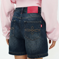 A close-up back view of a female model wearing the Smith's 1906 WSO01 Blue Denim Shorts.