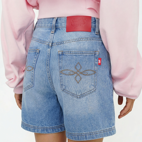 A close-up back view of a female model wearing the Smith's 1906 WSO01 Light Blue Denim Shorts.