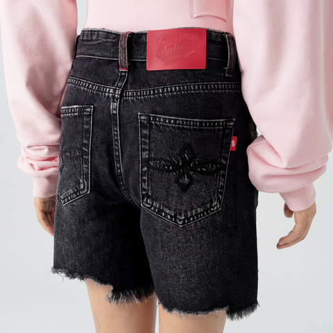 A close-up back view of a female model wearing the Smith's 1906 WSO02 Dark Grey Denim Shorts.