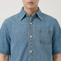 A close-up view of a male model wearing the Smith's 1906 MSR04 Light Blue Denim Short-Sleeve Shirt.