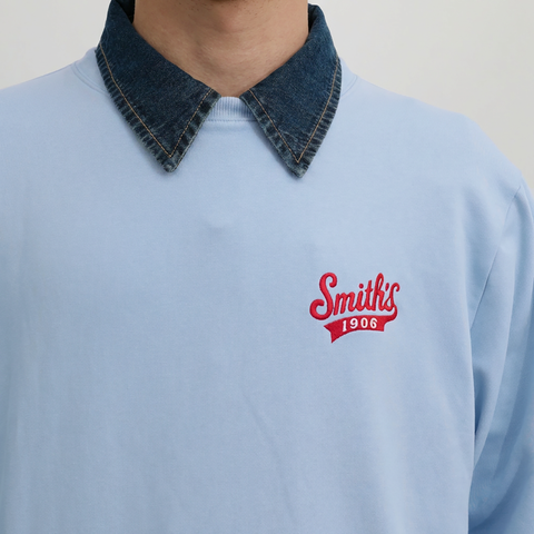 A close-up view of a male model wearing the Smith's 1906 MSW02 Light Blue Sweatshirt.