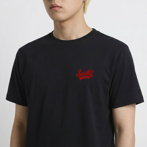 A close-up view of a male model wearing the Smith's 1906 MTE01 Black T-Shirt.