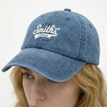 A close-up view of a female model wearing the Smith's 1906 UCP04 Blue Cap.