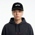 A male model wearing the Smith's 1906 UCP01 Black Cap is showing the front.