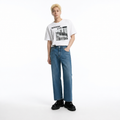 A male model is wearing a T-shirt paired with the Smith's 1906 MJN03 Blue Jeans.