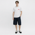 A male model is wearing shorts paired with the Smith's 1906 MPO01 White Polo.