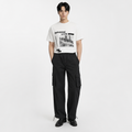 A male model is wearing a T-shirt paired with the Smith's 1906 MPT02 Black Pants.