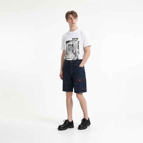 A male model is wearing a T-shirt paired with the Smith's 1906 MSO01 Navy Denim Shorts.
