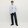 A male model is wearing jeans paired with the Smith's 1906 MSR02 Light Blue Shirt.