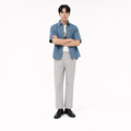 A male model is wearing  a pair of pants paired with the Smith's 1906 MSR04 Light Blue Denim Short-Sleeve Shirt.