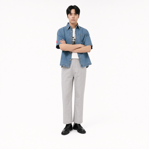 A male model is wearing  a pair of pants paired with the Smith's 1906 MSR04 Light Blue Denim Short-Sleeve Shirt.