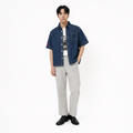 A male model is wearing  a pair of pants paired with the Smith's 1906 MSR04 Navy Denim Short-Sleeve Shirt.