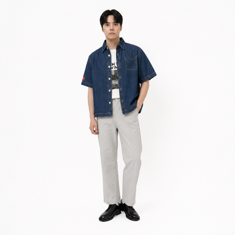 A male model is wearing  a pair of pants paired with the Smith's 1906 MSR04 Navy Denim Short-Sleeve Shirt.