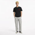 A male model is wearing a pair of pants paired with the Smith's 1906 MTE01 Black T-Shirt.