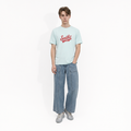 A male model is wearing a pair of jeans paired with the Smith's 1906 MTE02 Blue T-Shirt.