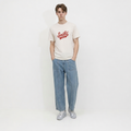 A male model is wearing a pair of jeans paired with the Smith's 1906 MTE02 Off White T-Shirt.