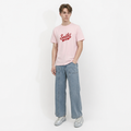 A male model is wearing a pair of jeans paired with the Smith's 1906 MTE02 Pink T-Shirt.