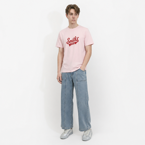A male model is wearing a pair of jeans paired with the Smith's 1906 MTE02 Pink T-Shirt.