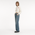 A female model is wearing a pair of jeans paired with the Smith's 1906 WHO01 Beige Hoodie.