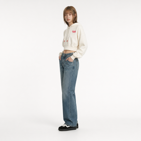 A female model is wearing a pair of jeans paired with the Smith's 1906 WHO01 Beige Hoodie.