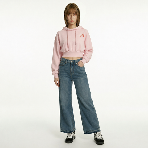 A female model is wearing a pair of jeans paired with the Smith's 1906 WHO01 Pink Hoodie.