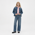 A female model is wearing a pair of jeans paired with the Smith's 1906 WJK02 Dark Blue Denim Jacket.