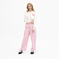 A female model is wearing a hoodie paired with the Smith's 1906 WPT01 Pink Pants.
