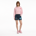 A female model is wearing a hoodie paired with the Smith's 1906 WSO01 Blue Denim Shorts.