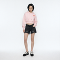 A female model is wearing a hoodie paired with the Smith's 1906 WSO02 Dark Grey Denim Shorts.