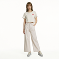 A female model is wearing a pair of pants paired with the Smith's 1906 WTE01 Beige T-shirt.
