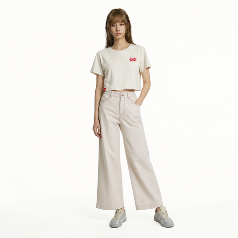 A female model is wearing a pair of pants paired with the Smith's 1906 WTE01 Beige T-shirt.