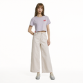 A female model is wearing a pair of pants paired with the Smith's 1906 WTE01 Lilac T-shirt.